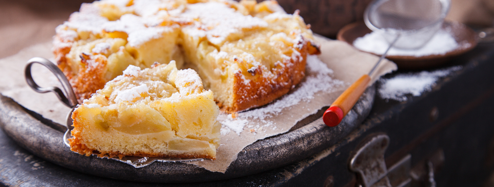 Apple,Cake,On,A,Vintage,Suitcase,In,Powdered,Sugar.selective,Focus.